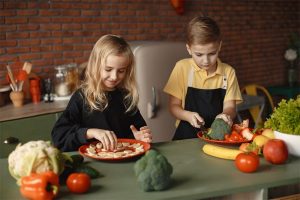 children slicing vegetables