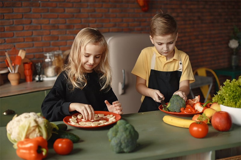 children slicing vegetables